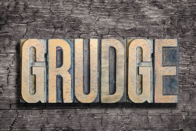 grudge word made from vintage letterpress type on burned wood