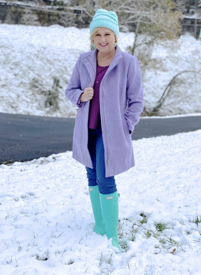 Purple coat and blue boots in the snow