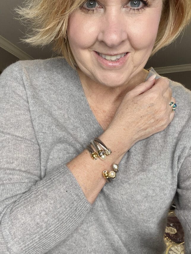 Fashion Blogger 50 Is Not Old holds a try on session and shows 3 silver bracelets