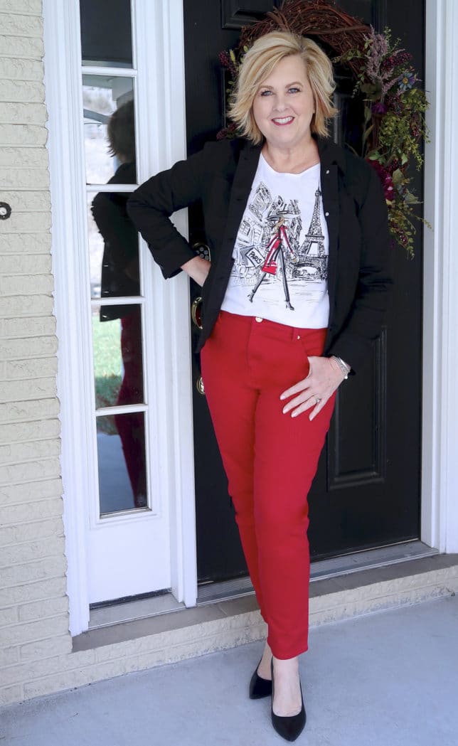 FASHION BLOGGER 50 IS NOT OLD IS WEARING A BLACK DENIM JACKET AND RED PANTS FROM CHICO'S