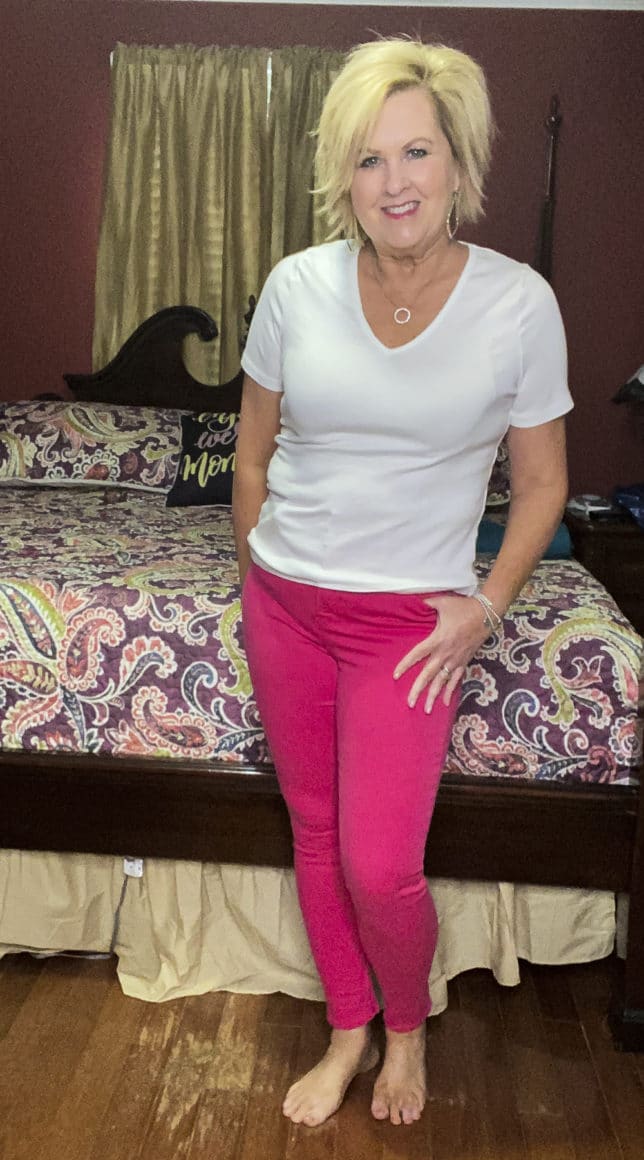 Old Navy try-on haul by Fashion Blogger 50 Is Not Old and she is wearing a white v-neck t-shirt and a pair of bright pink skinny jeans