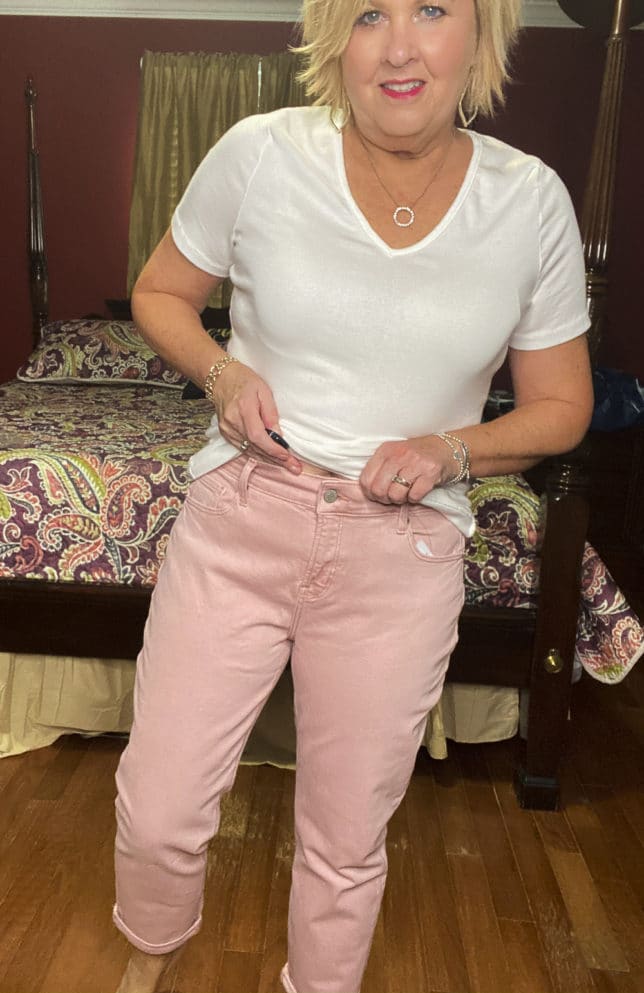 Old Navy try-on haul by Fashion Blogger 50 Is Not Old and she is wearing a white v-neck t-shirt and a pair of pink boyfriend jeans