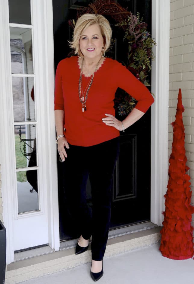 Fashion Blogger 50 Is Not Old is wearing a classical look with a red v-neck sweater from Loft and black velveteen pants