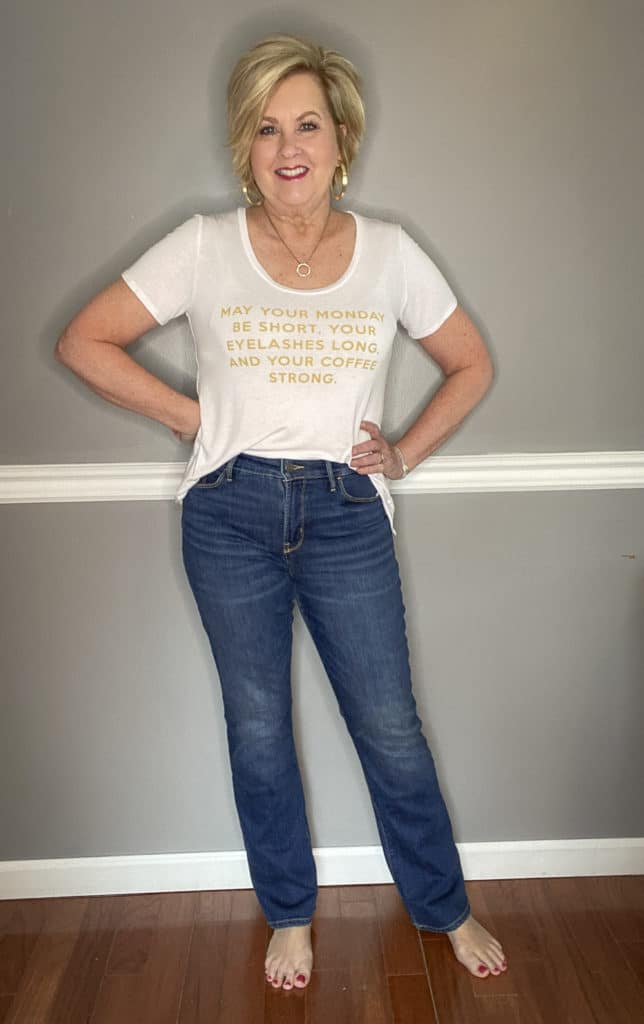 Fashion Blogger 50 Is Not Old wearing a white t-shirt with gold writing and jeans