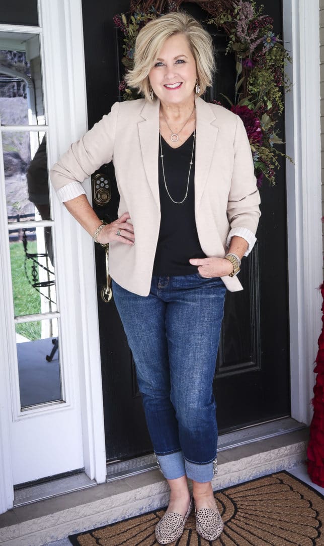 Fashion Blogger 50 Is Not Old in a taupe Ponte knit blazer, a black v-neck t-shirt, and cuffed jeans