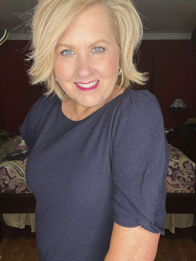 Fashion Blogger 50 Is Not Old is wearing a navy blue sweater with puff sleeves from Loft