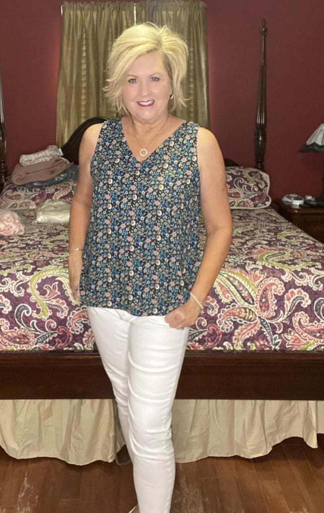 Fashion Blogger 50 Is Not Old is wearing a floral tank top with white skinny jeans