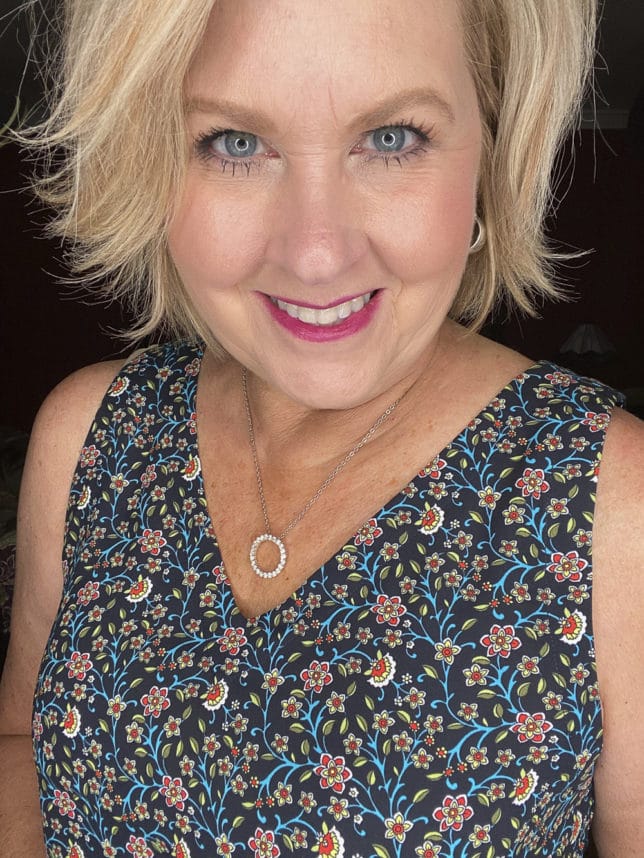 Fashion Blogger 50 Is Not Old is wearing a floral tank top 