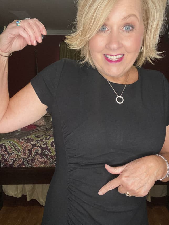 Fashion Blogger 50 Is Not Old is wearing a black ruched dress from Loft