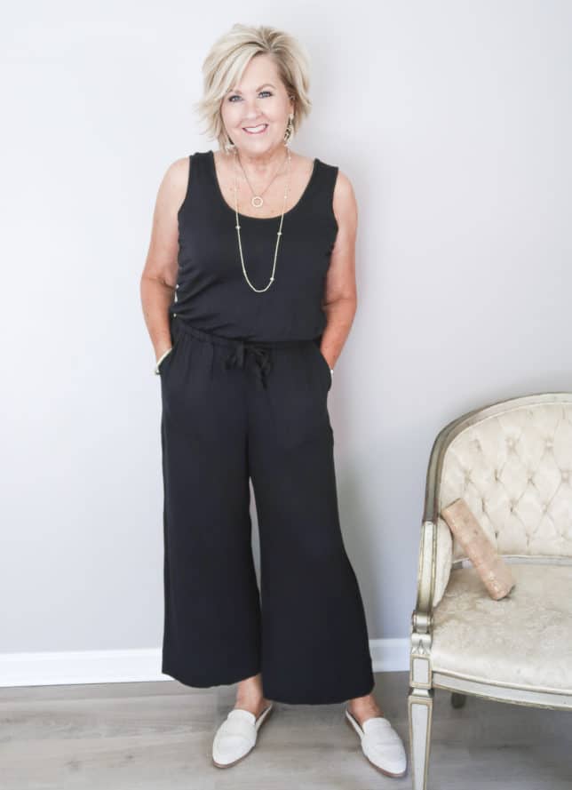 50 Is Not Old is wearing a black sleeveless wide leg ankle length jumper with linen mules