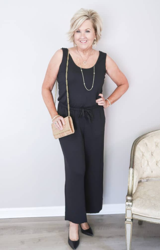 50 Is Not Old is wearing a black sleeveless wide leg jumper with black pumps