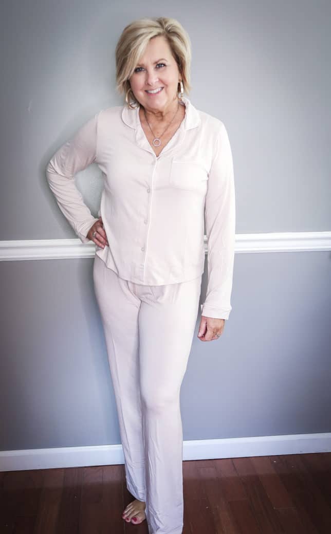 Fashion Blogger 50 Is Not Old wearing a pale pink pajama set with long pants and sleeves