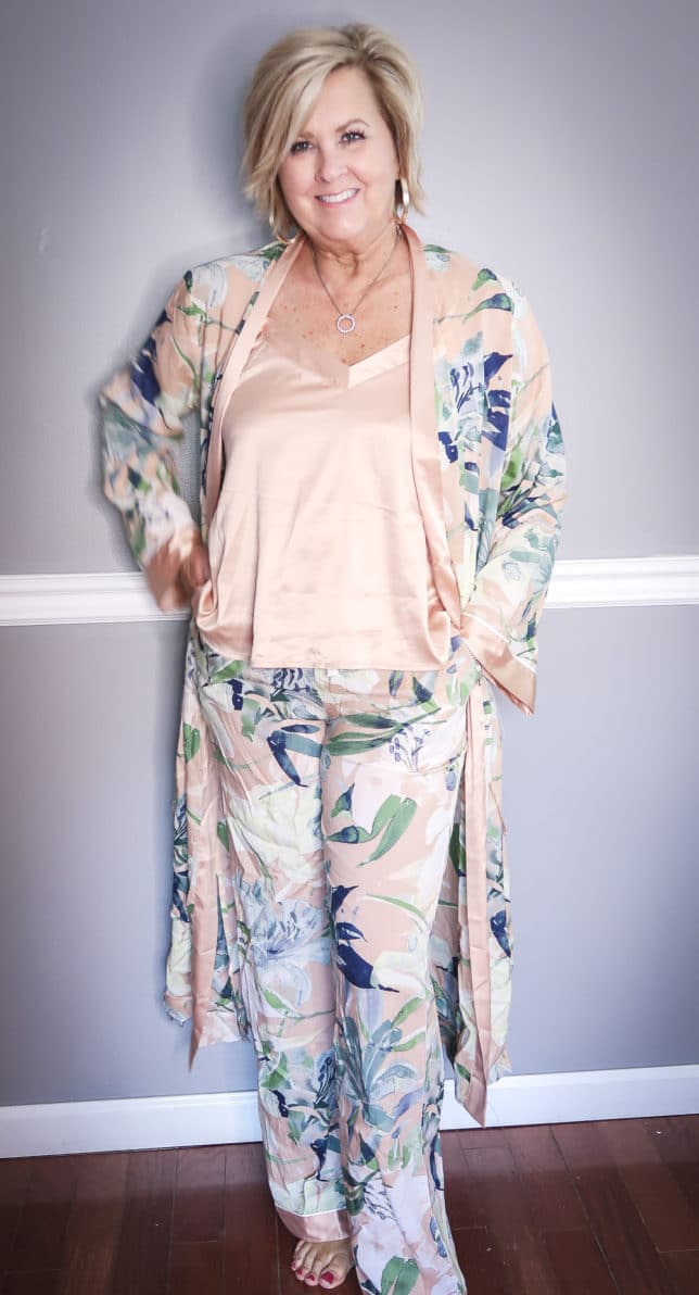 Fashion Blogger 50 Is Not Old wearing a floral robe with matching pants and a camisole 