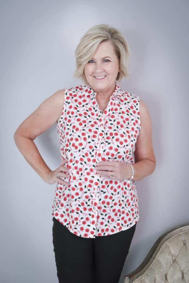 Fashion Blogger 50 Is Not Old is wearing a sleeveless cheery print top 