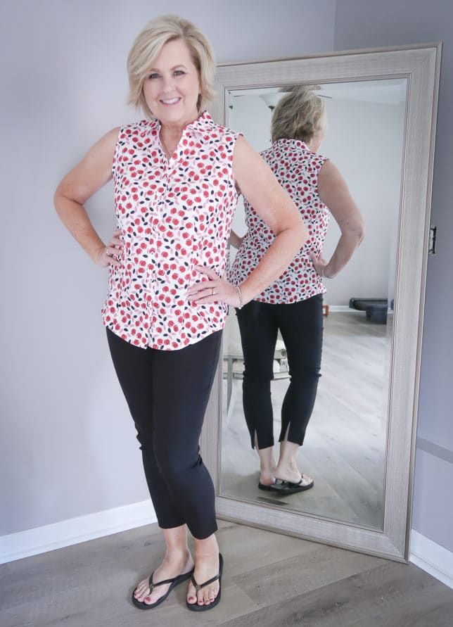 Fashion Blogger 50 Is Not Old is wearing a sleeveless tulip print top with a pair of black crop pants and black flip flops