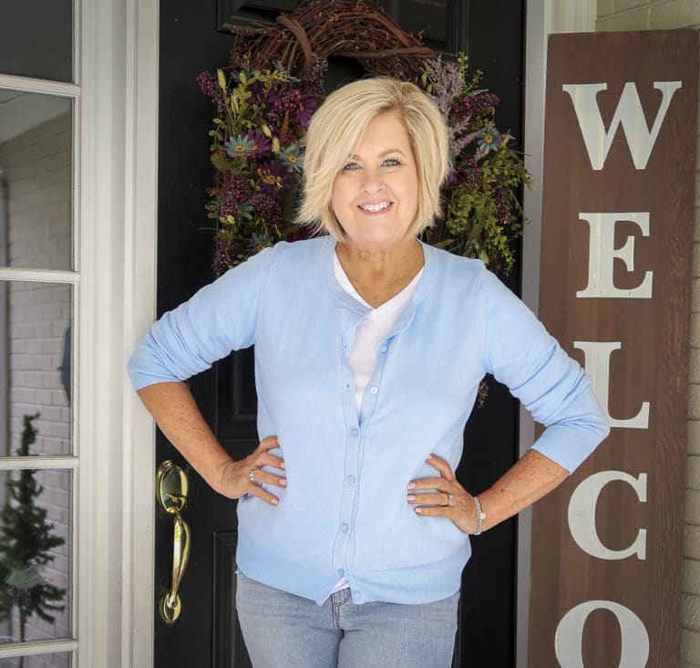 Fashion Blogger 50 Is Not Old is wearing a light blue cardigan and a white v-neck t-shirt