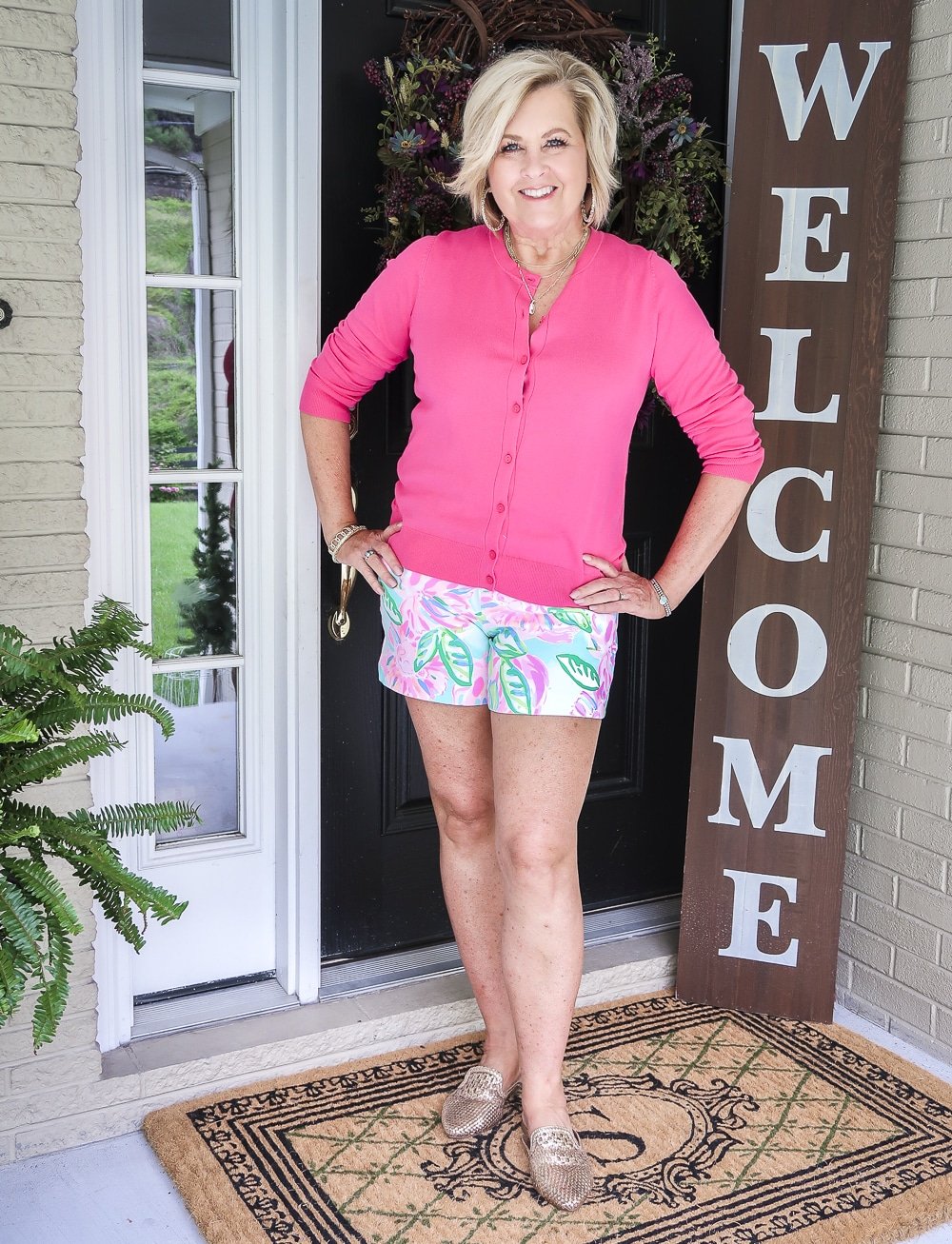 Fashion Blogger 50 Is Not Old is wearing a racy pink cardigan from Walmart with a pair of shorts by Lilly Pulitzer