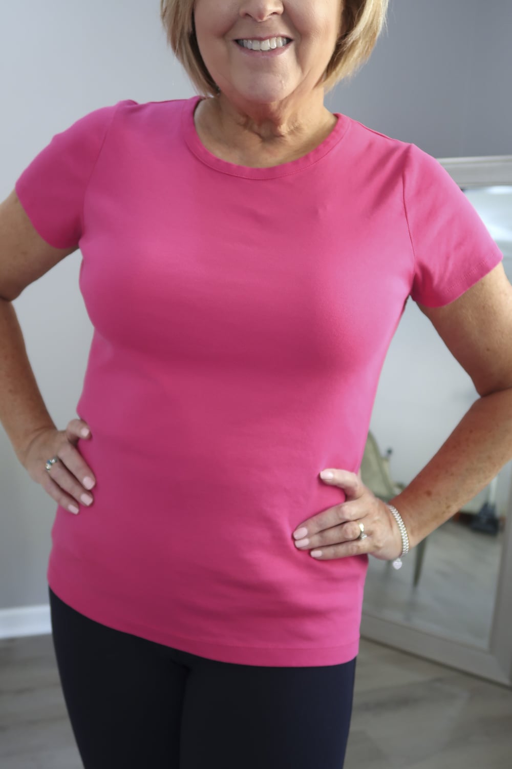 Fashion Blogger 50 Is Not Old is wearing a pink t-shirt 