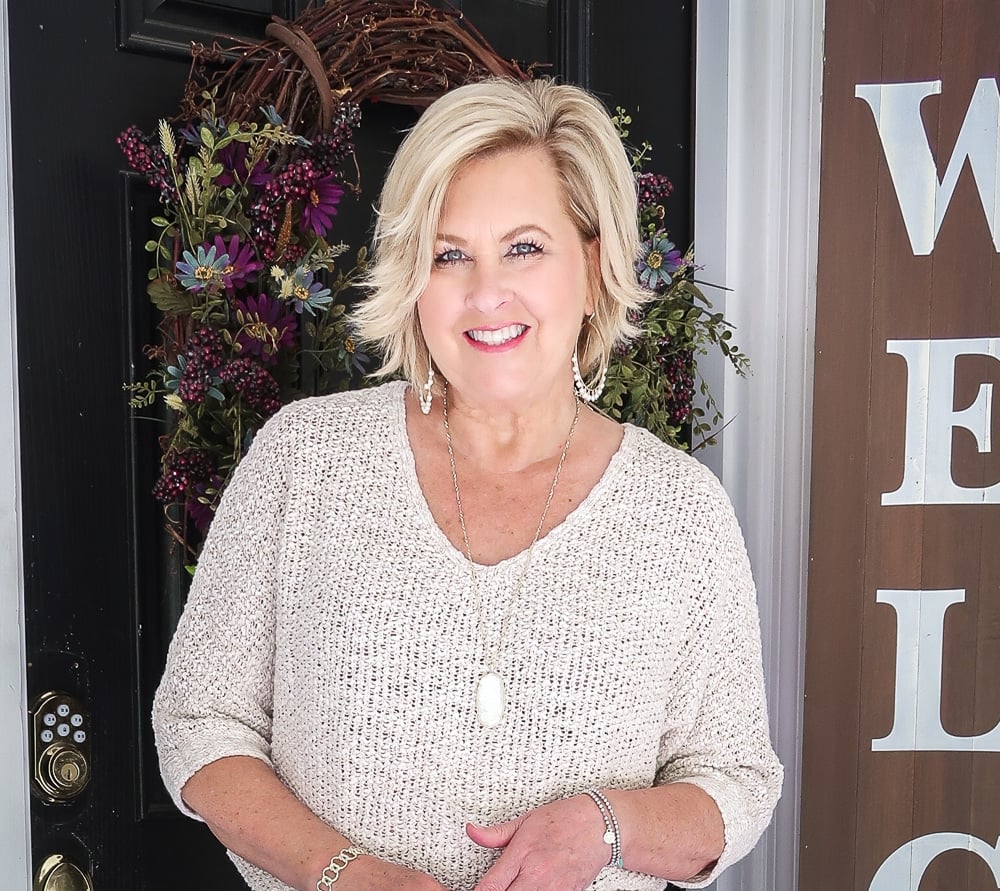 Fashion Blogger 50 Is Not Old is wearing a Sand colored sweater with gold jewelry