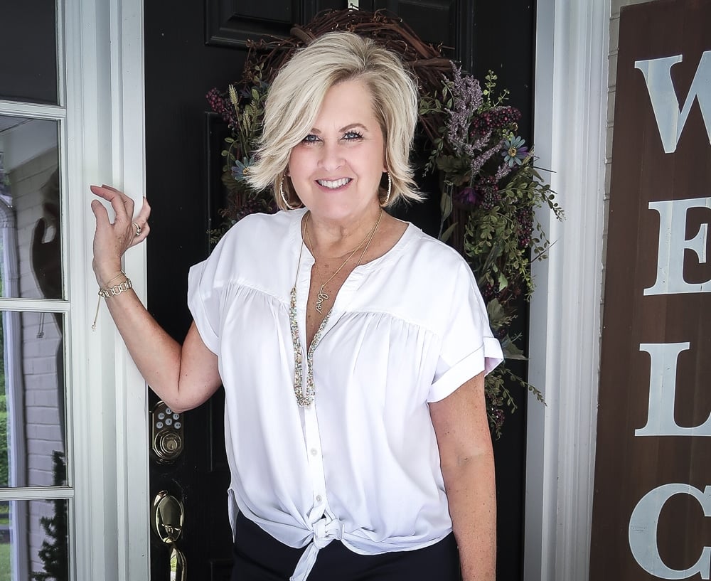 Fashion Blogger 50 Is Not Old is wearing a white tie-front top