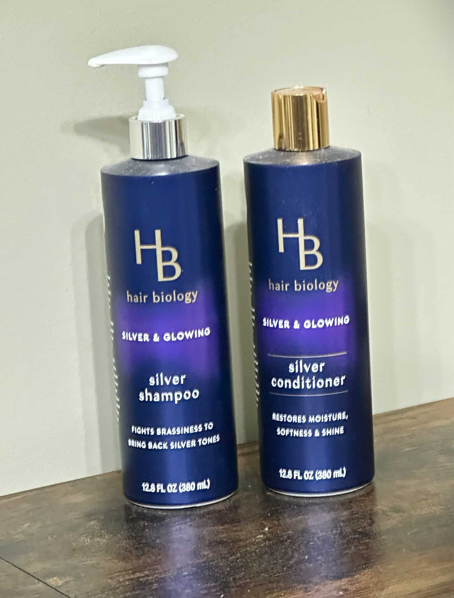 Over 50 Fashion Blogger, Tania Stephens is holding a few of her favorite things, Hair Biology shampoo