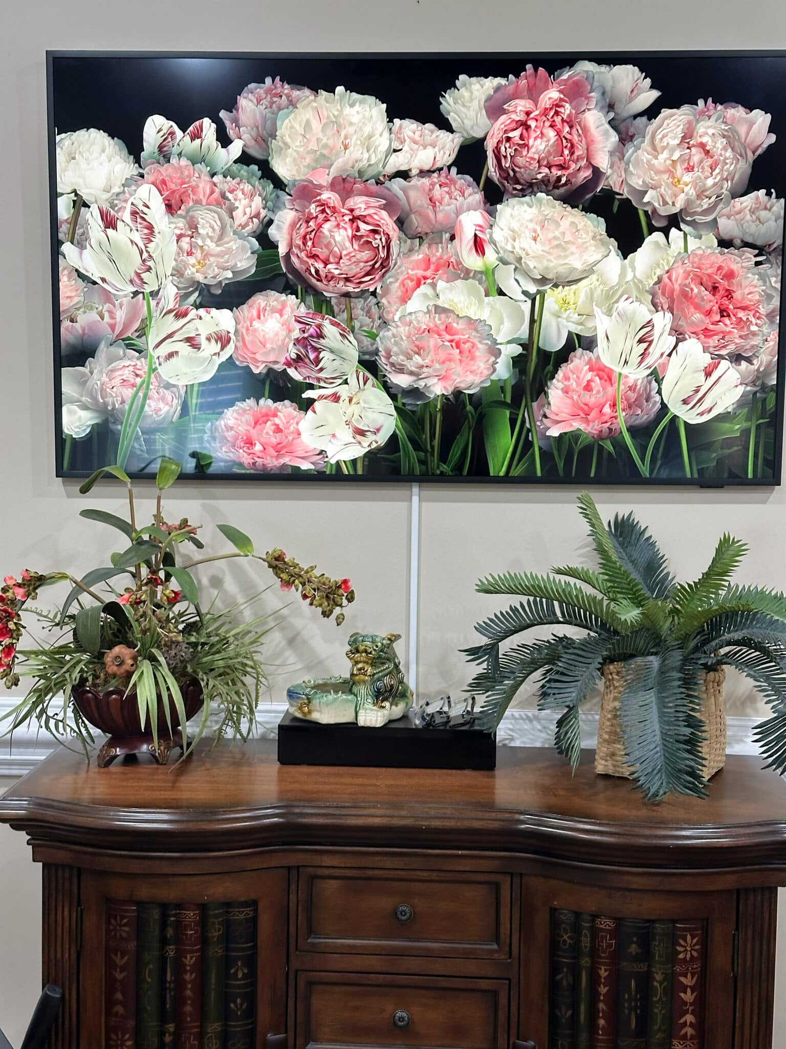 Over 50 Fashion Blogger, Tania Stephens is holding a few of her favorite things, the Frame TV