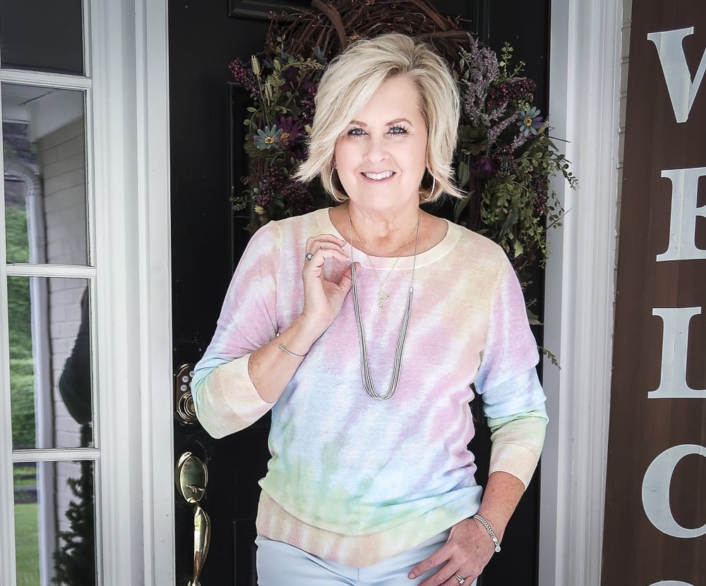 Fashion Blogger 50 Is Not Old is wearing a gorgeous tie-dye sweater with silver jewelry