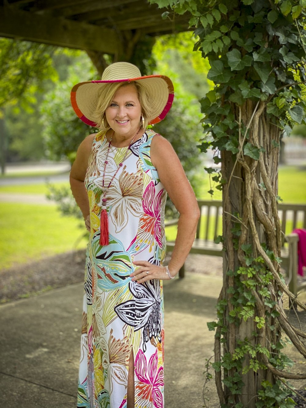 Fashion Blogger 50 Is Not Old is wearing a tropical print sleeveless dress with colorful accessories