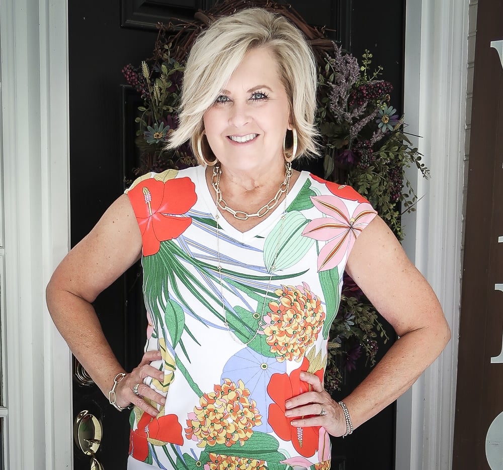 Fashion Blogger 50 Is Not Old is wearing a bright and bold side-tie sweater with gold jewelry