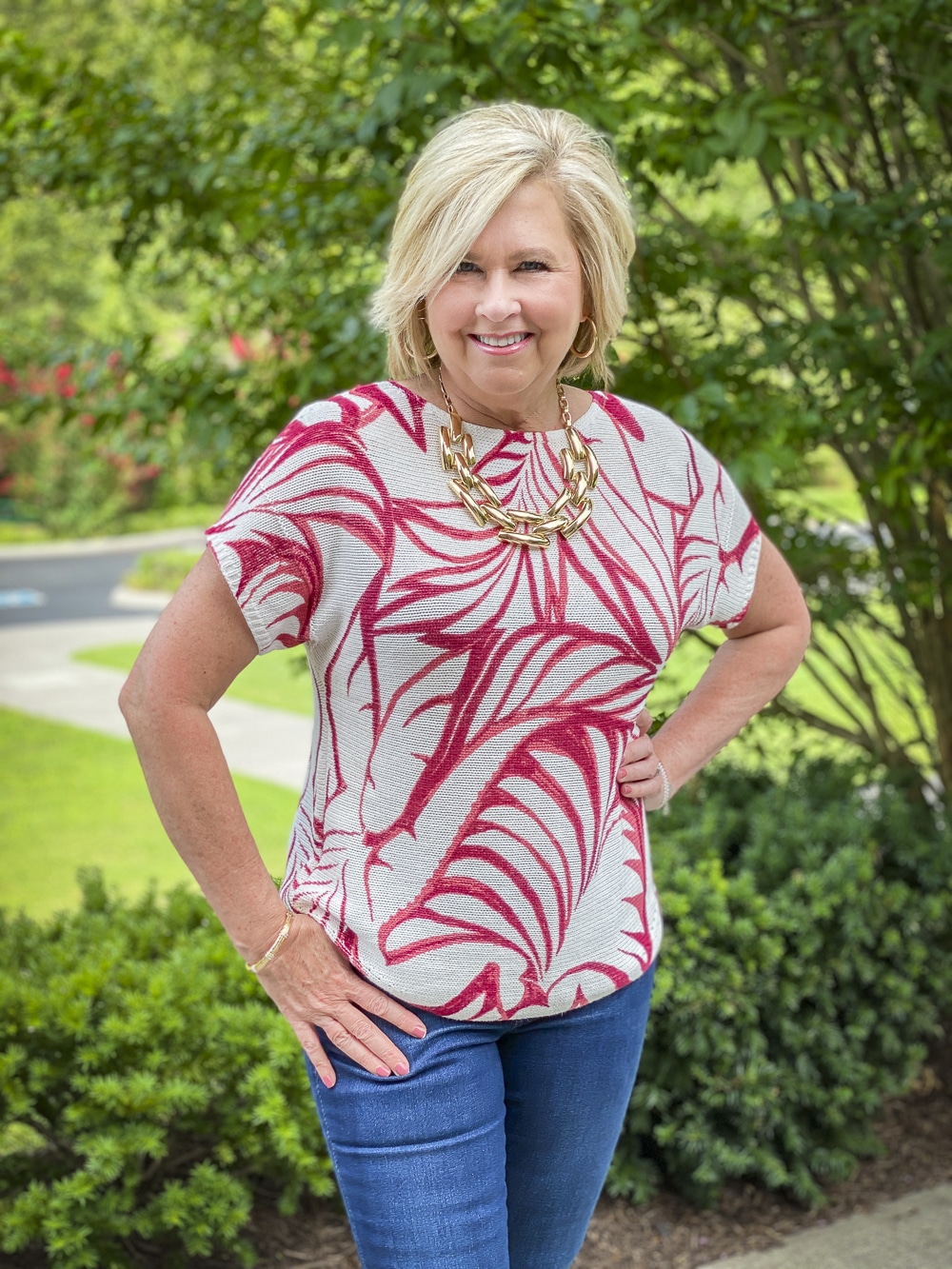 Fashion Blogger 50 Is Not Old is ready for a staycation in her red and white tropical leaf print sweater