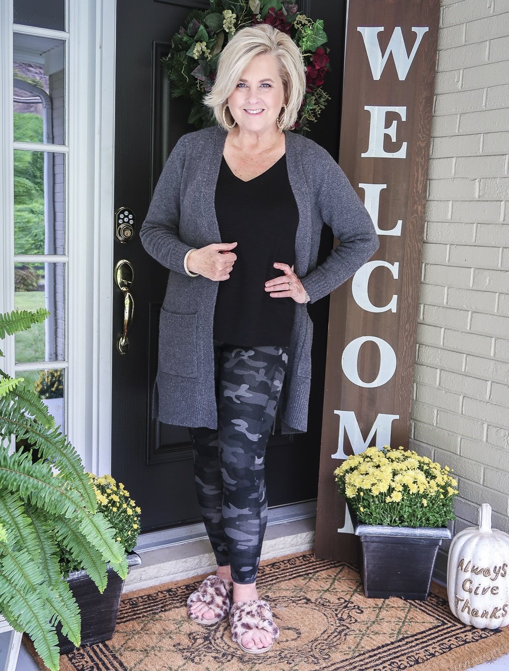 Fashion Blogger 50 Is Not Old is wearing a soft and cozy long gray cardigan with a black v-neck tank top and camo leggings from Chico's