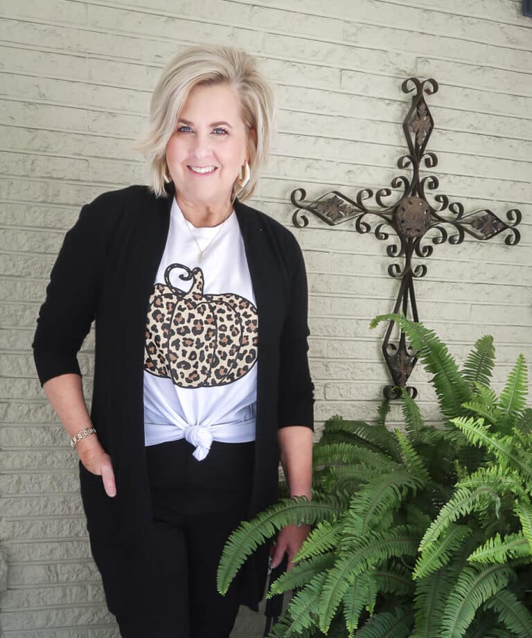 Fashion Blogger 50 Is Not Old is wearing a leopard print pumpkin t-shirt with a long black cardigan and black skinny jeans