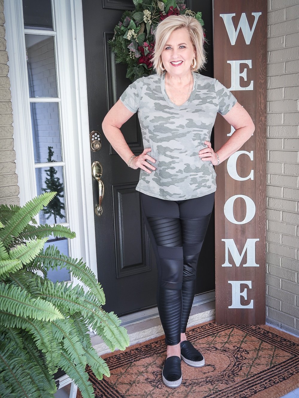 Fashion Blogger 50 Is Not Old is doing a Tuesday Try-On Session with Target and styling a camo v-neck tee shirt with black moto leggings