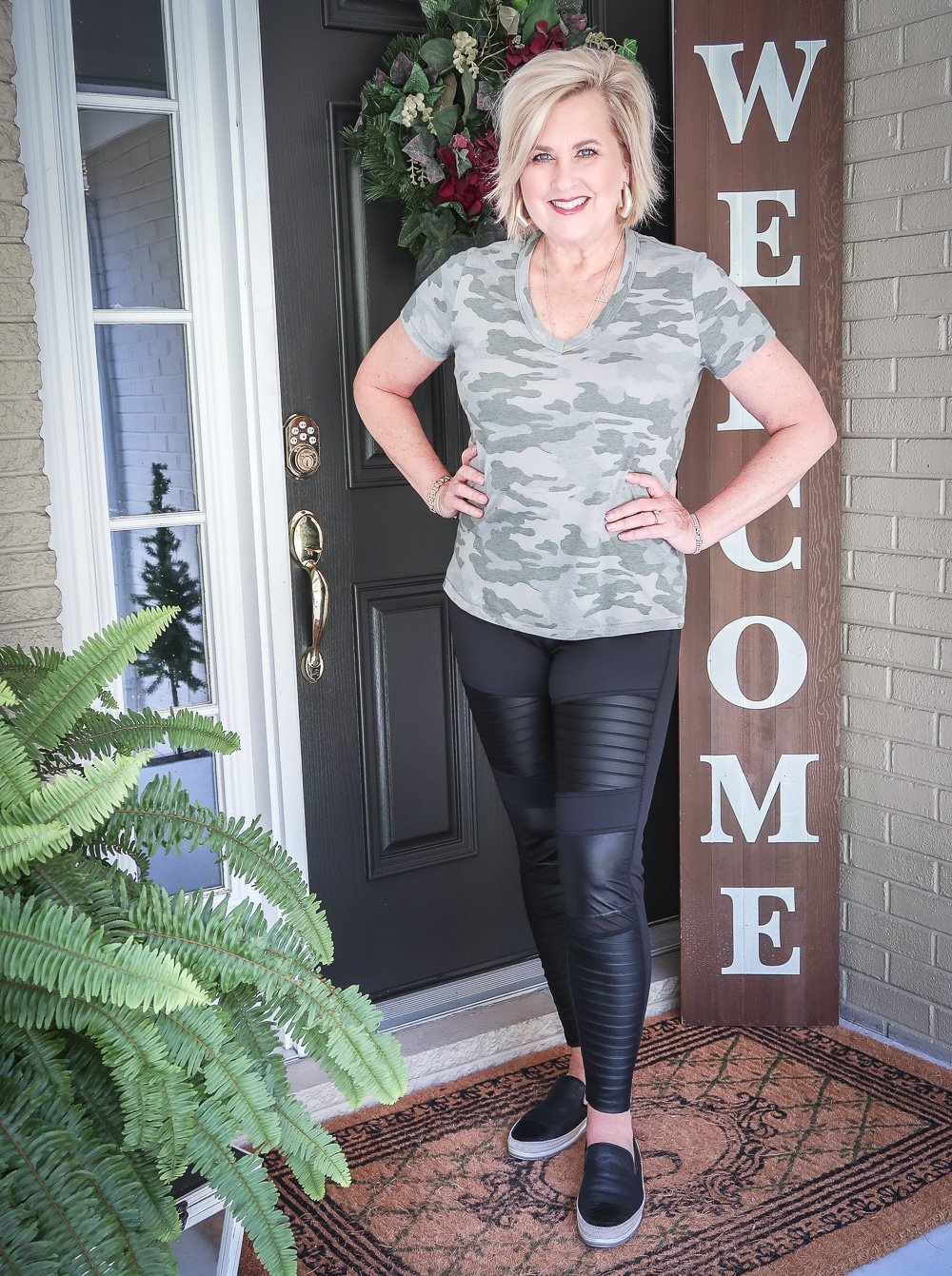 Fashion Blogger 50 Is Not Old is doing a Tuesday Try-On Session with Target and styling a camo v-neck tee shirt and black moto leggings
