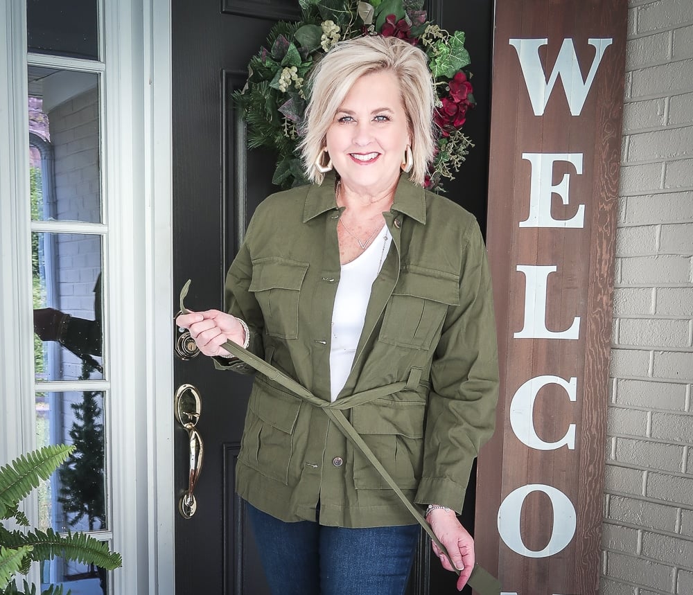 Fashion Blogger 50 Is Not Old is doing a Tuesday Try-On Session with Target and styling a green trucker jacket and a white v-neck tee shirt