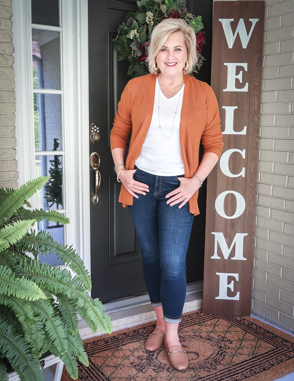 Fashion Blogger 50 Is Not Old is doing a Tuesday Try-On Session with Target and styling a rust cardigan, a white v-neck tee shirt, and dark jeans from Chico's