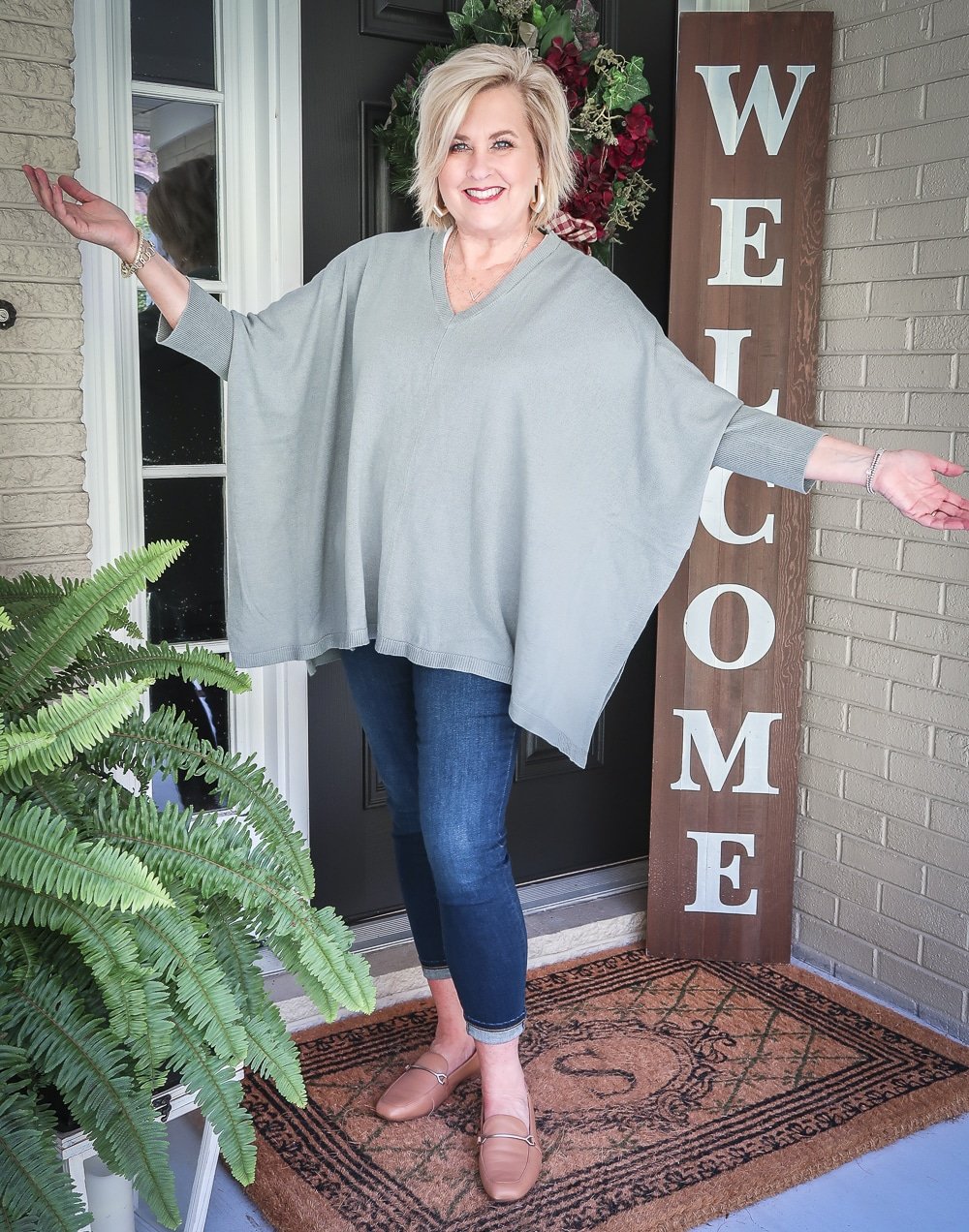 Fashion Blogger 50 Is Not Old is doing a Tuesday Try-On Session with Target and styling a marble green poncho, a white v-neck tee shirt, and dark jeans from Chico's
