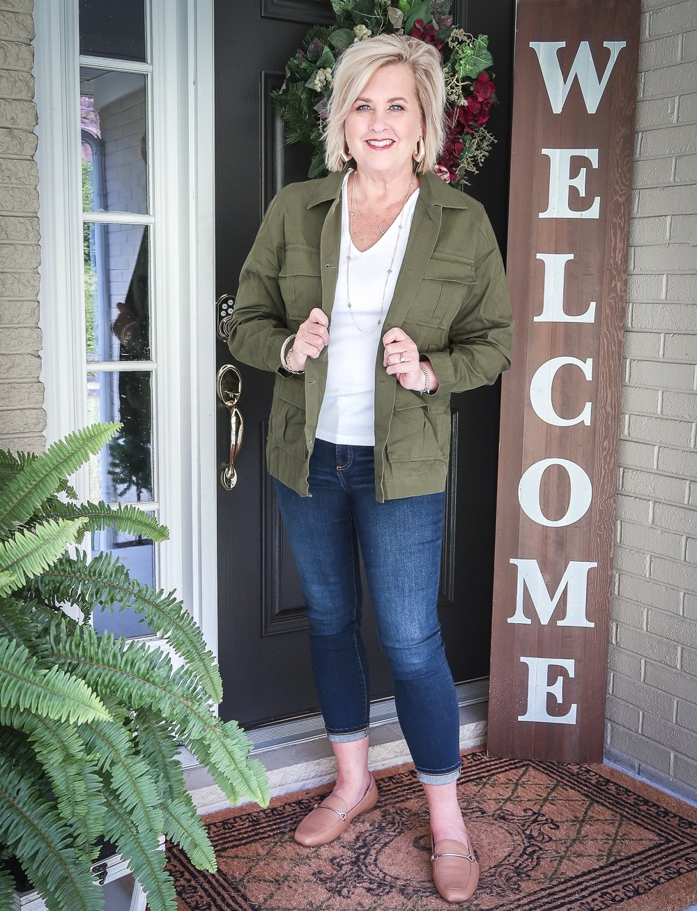 Fashion Blogger 50 Is Not Old is doing a Tuesday Try-On Session with Target and styling a green trucker jacket with a white v-neck tee shirt