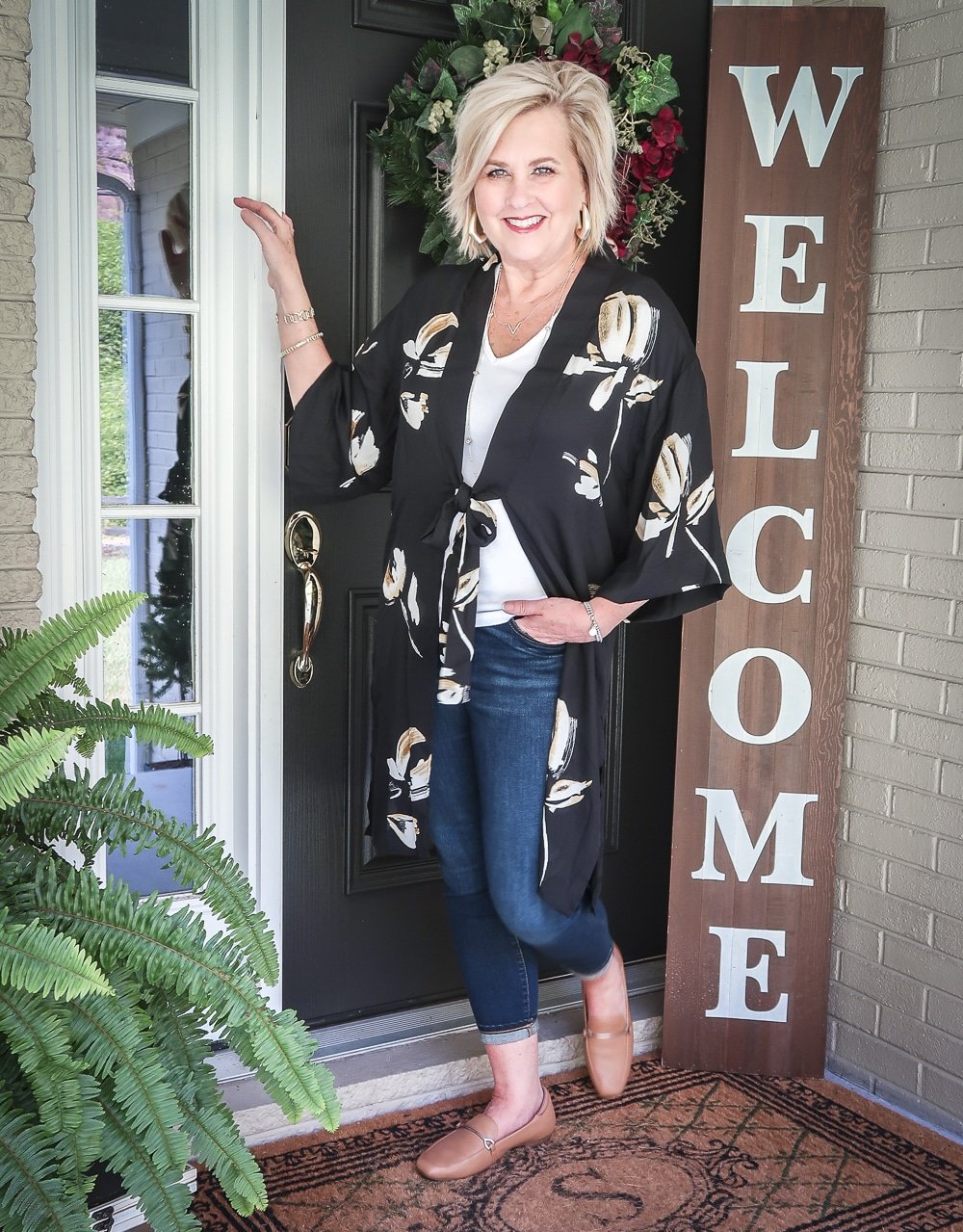 Fashion Blogger 50 Is Not Old is doing a Tuesday Try-On Session with Target and styling a black floral kimono, a white v-neck tee shirt, and dark jeans from Chico's