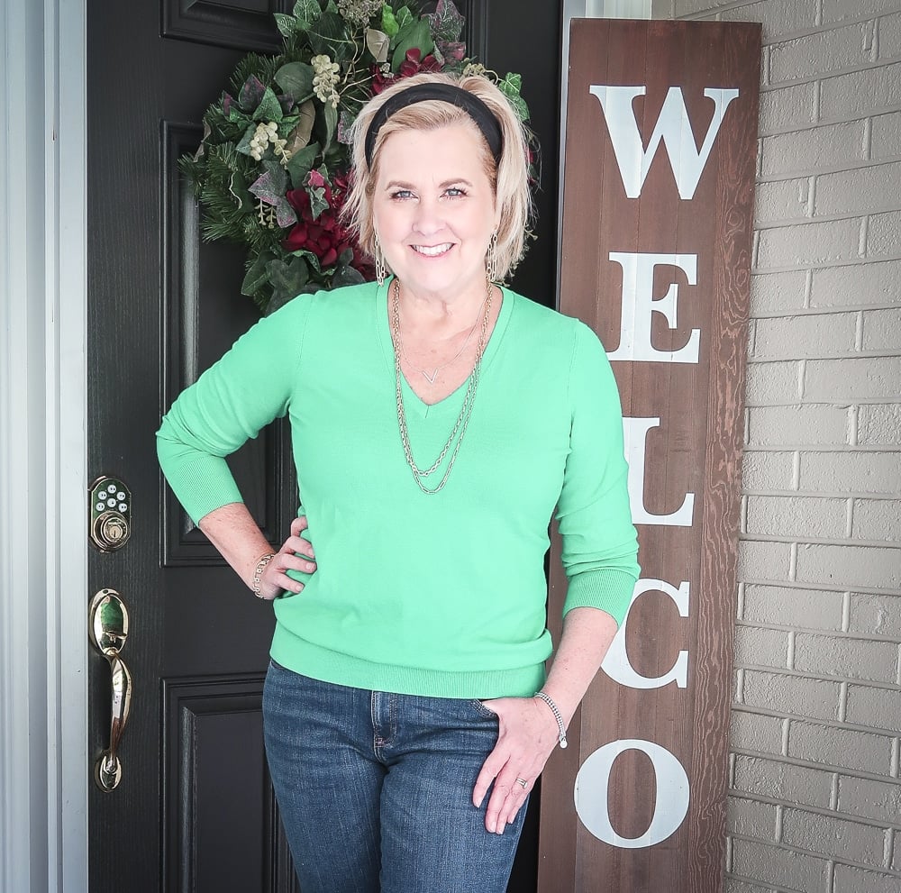 Fashion Blogger 50 Is Not Old is wearing a vibrant green v-neck sweater