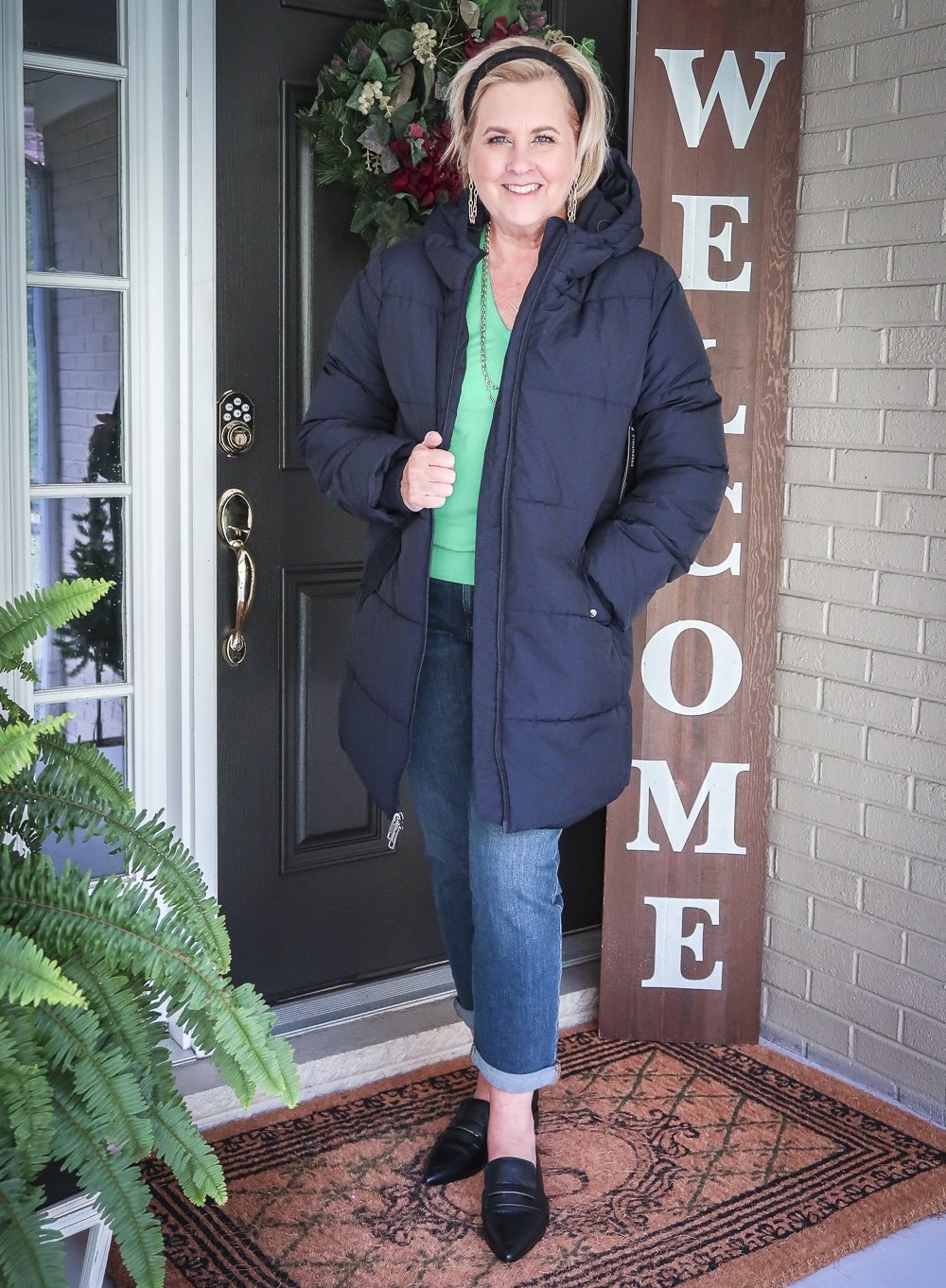 Fashion Blogger 50 Is Not Old is wearing a puffer coat with crop jeans and pointed-toe loafers