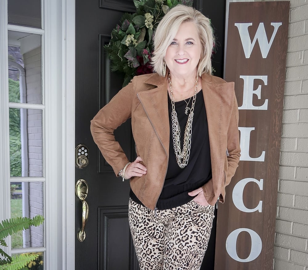 Fashion Blogger 50 Is Not Old is over 40 and still looks young and fabulous in this black top and cheetah print jeans with the Faux-Leather Moto Jacket from Chicos