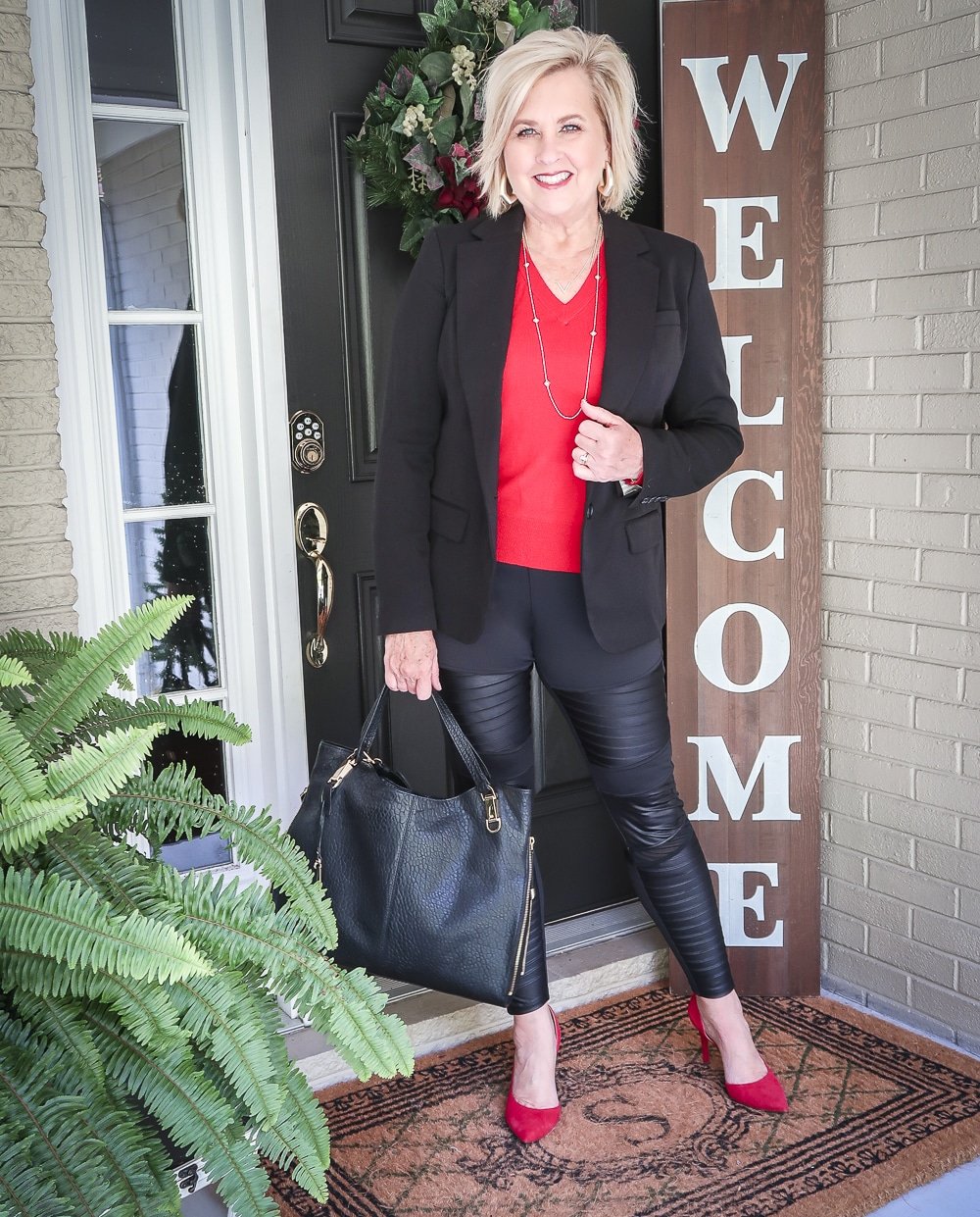 Fashion Blogger 50 Is Not Old is looking modern and edgy in this pair of black faux leather moto leggings and a red sweater and red pumps