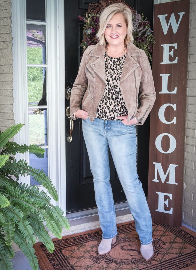 Fashion Blogger 50 Is Not Old is wearing a neutral outfit consisting of a leopard print camisole with a suede moto jacket