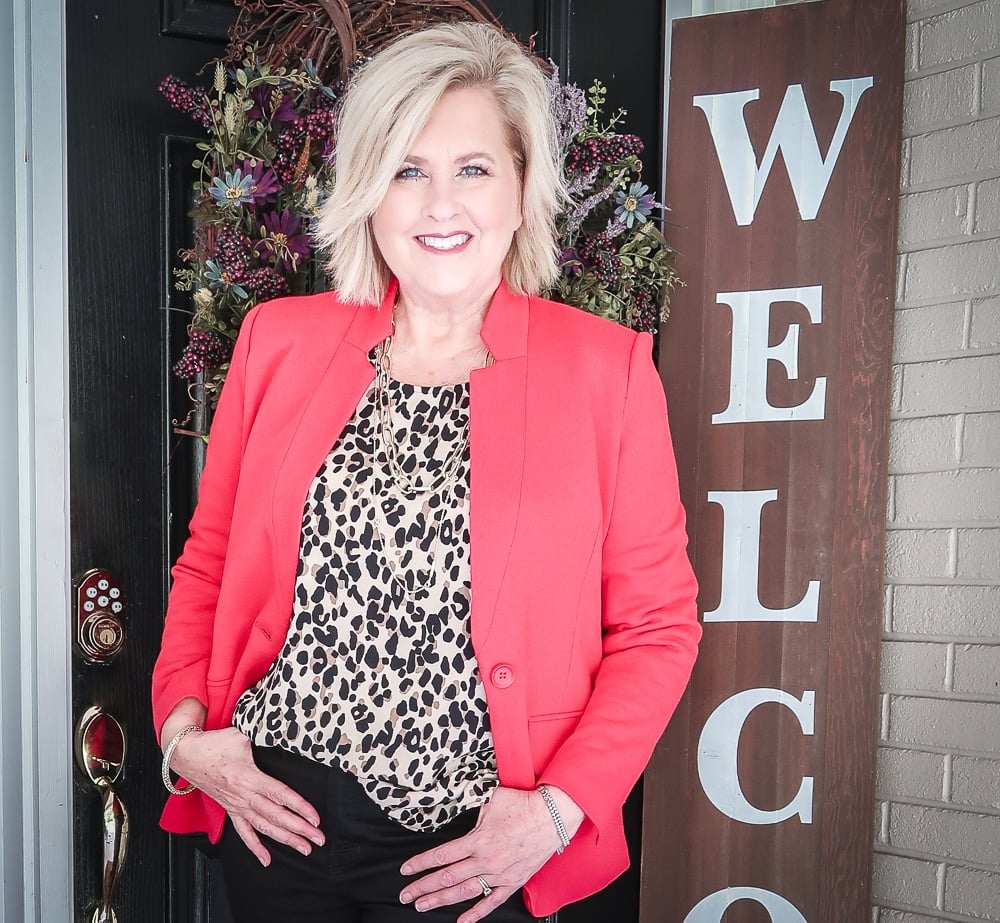 Fashion Blogger 50 Is Not Old is wearing a leopard print statement top and a red blazer