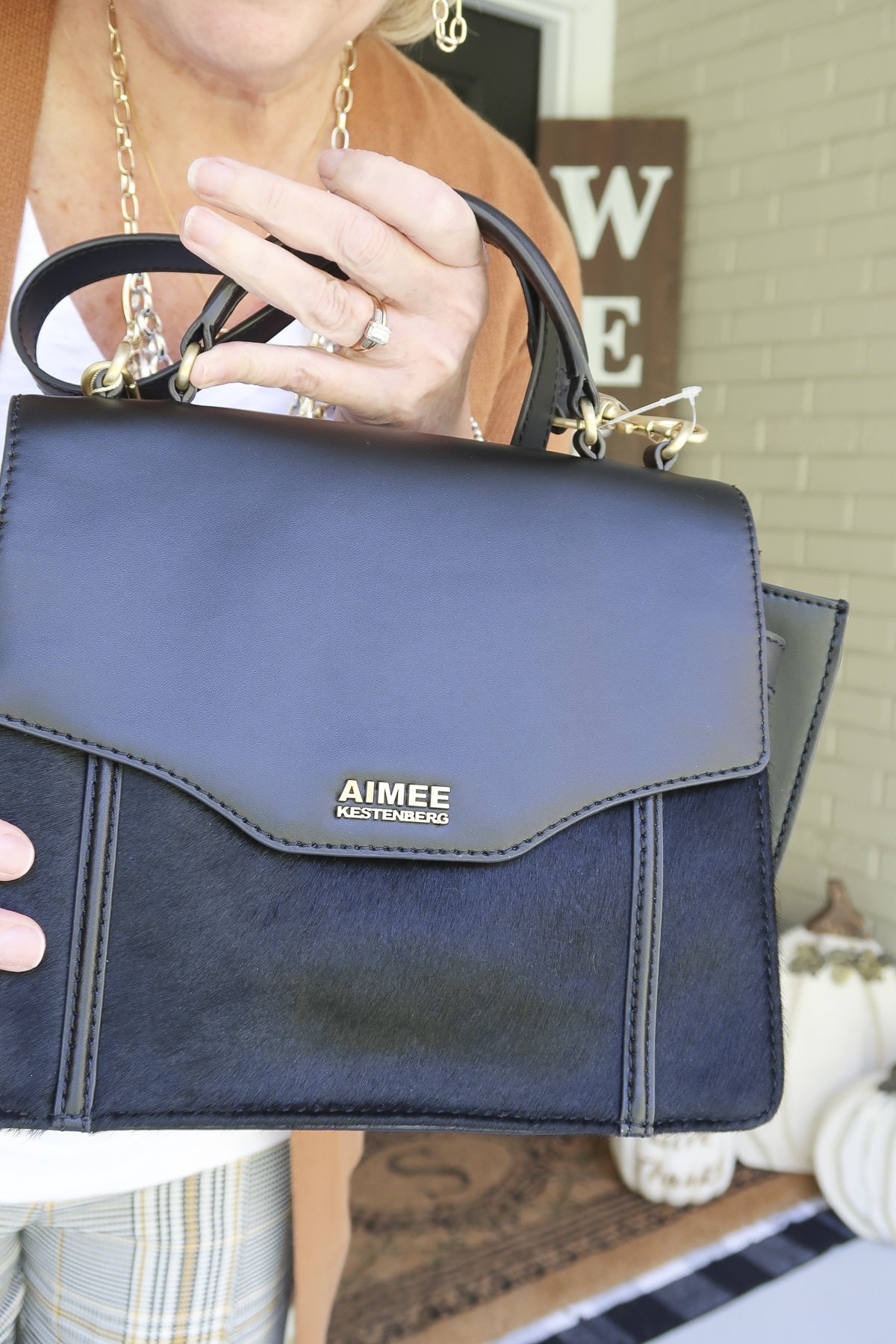 Fashion Blogger 50 Is Not Old is showing a black haircalf handbag by Aimee Kenstenberg