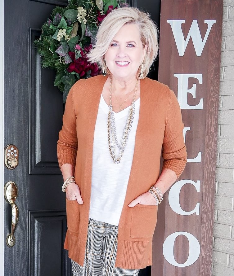 Fashion Blogger 50 Is Not Old is wearing a white tank with a caramel cardigan and jewelry by Kendra Scott
