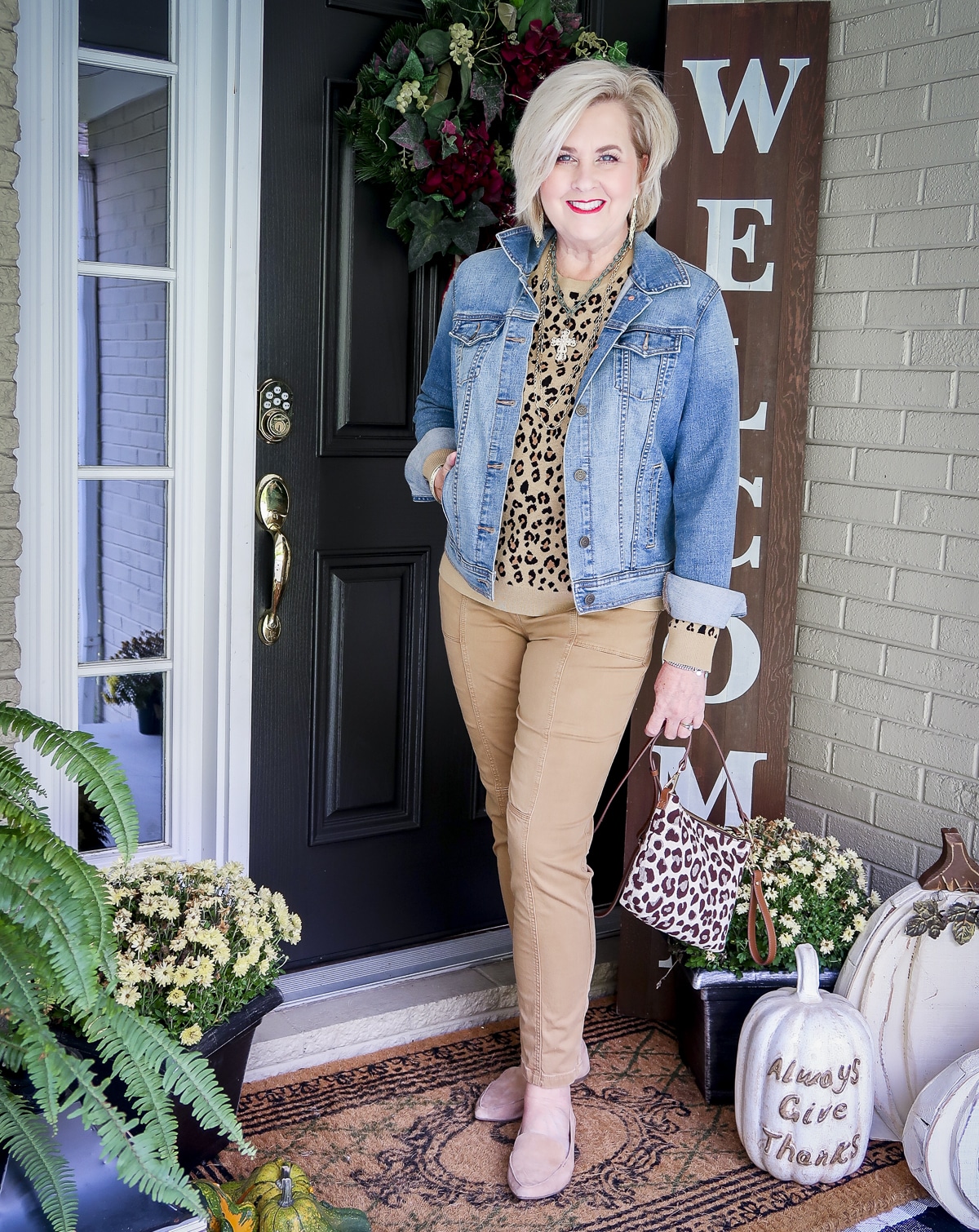 Fashion Blogger 50 Is Not Old is styling a leopard print sweater with a denim jacket and utility pants from Chico's