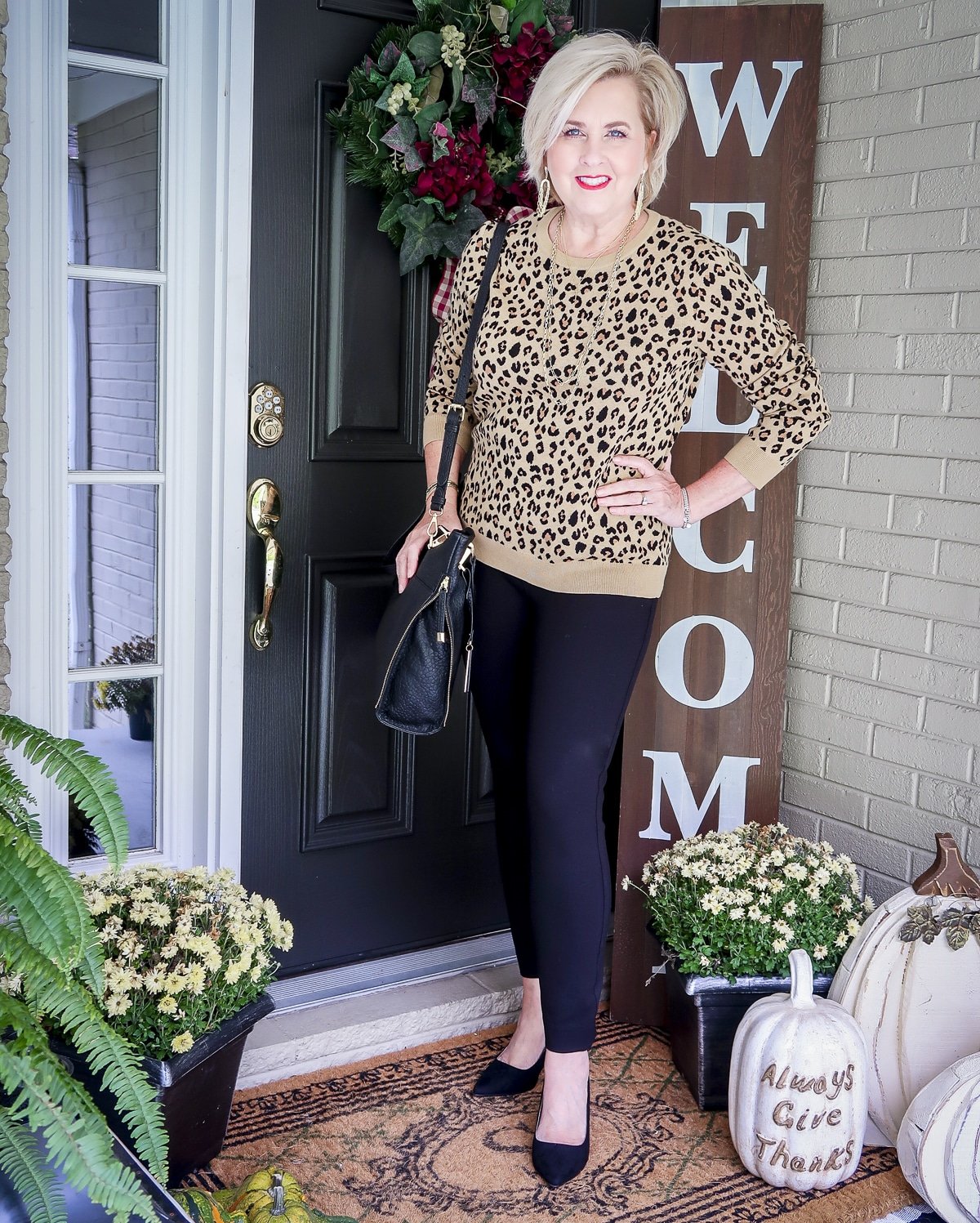 Fashion Blogger 50 Is Not Old is styling a leopard print sweater with black SPANX pants