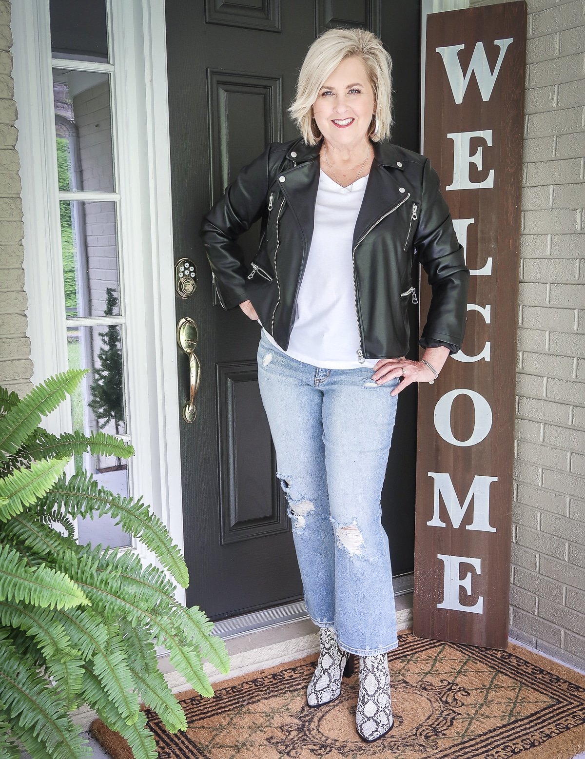 Fashion Blogger 50 Is Not Old keeps looking young with a moto jacket and distressed jeans